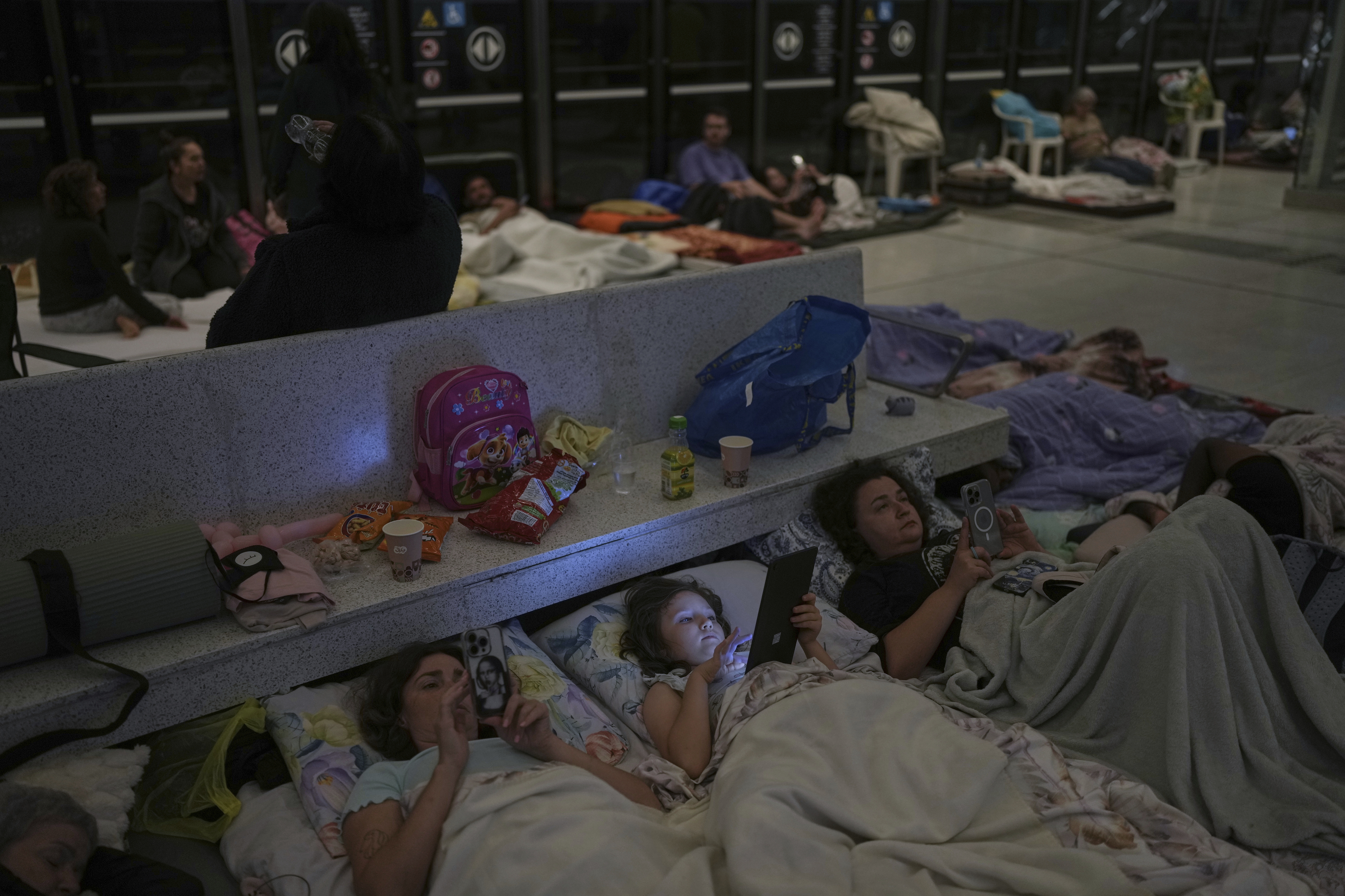 People in Ramat Gan, near Tel Aviv, shelter in an underground metro station