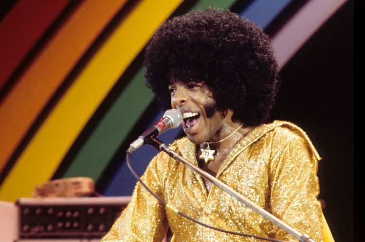 Sly Stone performing at a concert.