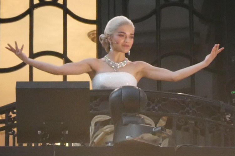 Rachel Zegler performing on a balcony.