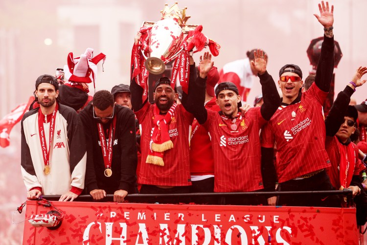 Liverpool players celebrating their Premier League victory in a parade.