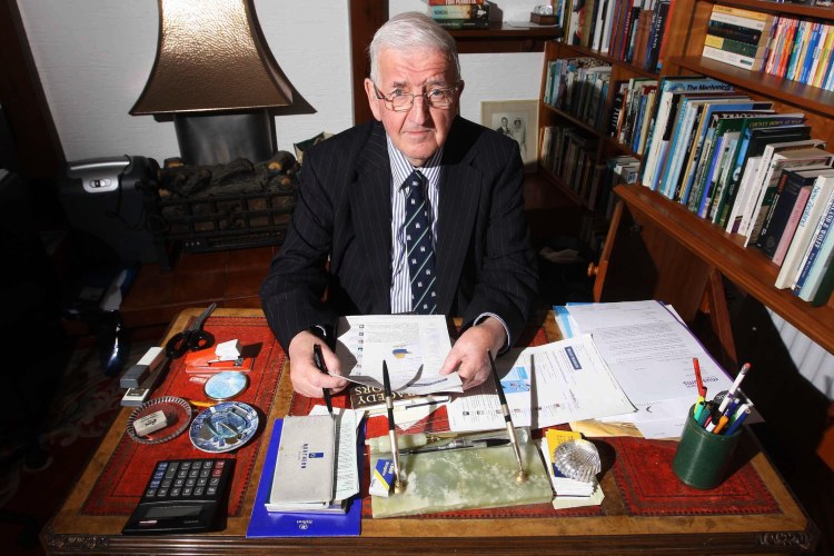 Sir Kenneth Bloomfield, former head of the Northern Ireland Civil Service, at his desk.