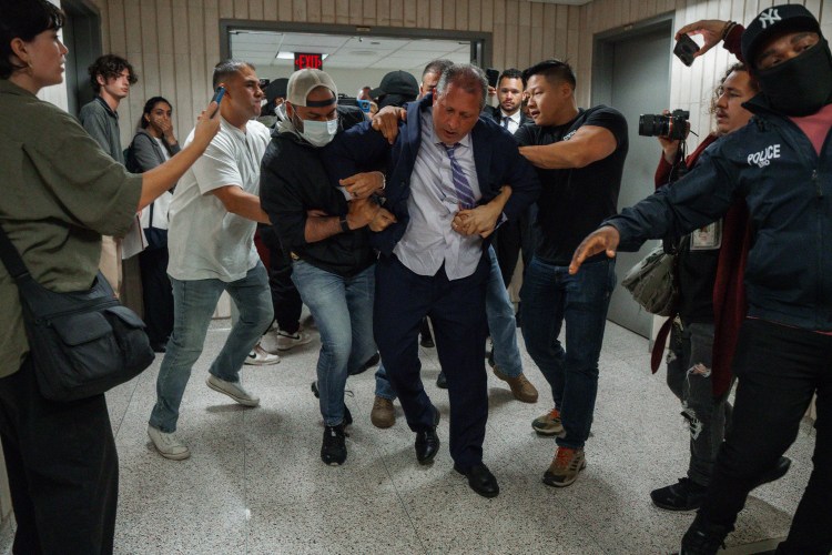New York City Comptroller Brad Lander being arrested by ICE and FBI agents outside a federal immigration court.