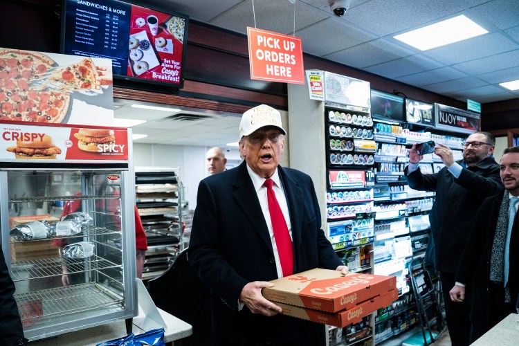 Donald Trump picking up some pies while campaigning in Iowa last year