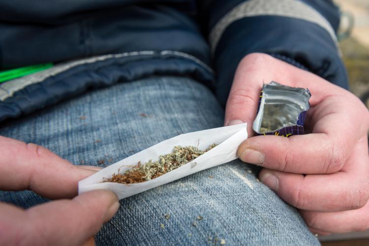 A person rolling a joint.