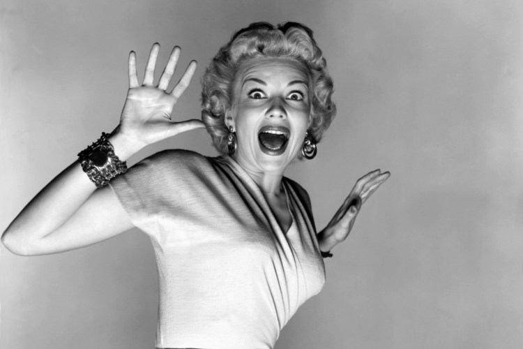 Black and white promotional photo of actress Kathleen Hughes reacting to aliens in the film *It Came From Outer Space*.