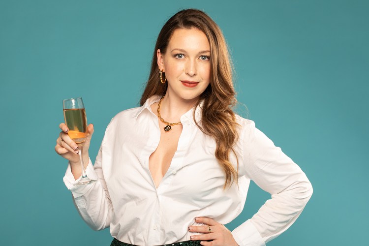 Woman holding a glass of champagne.