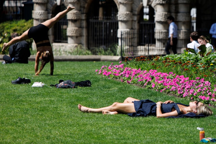 Person sunbathing in a London garden during a heatwave.
