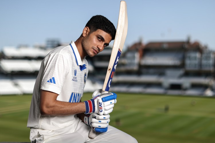 Portrait of Shubman Gill, Indian cricketer, holding a cricket bat.