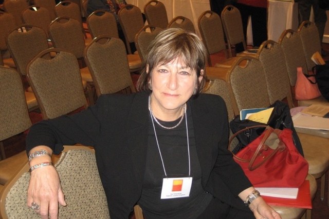 Photo of Joy Schaverien sitting in a conference room.