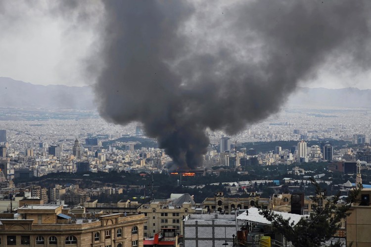 Smoke rises from a building in Tehran used by the Islamic Republic of Iran News Network, part of Iran’s state TV broadcaster, after an Israeli strike that interrupted its live coverage