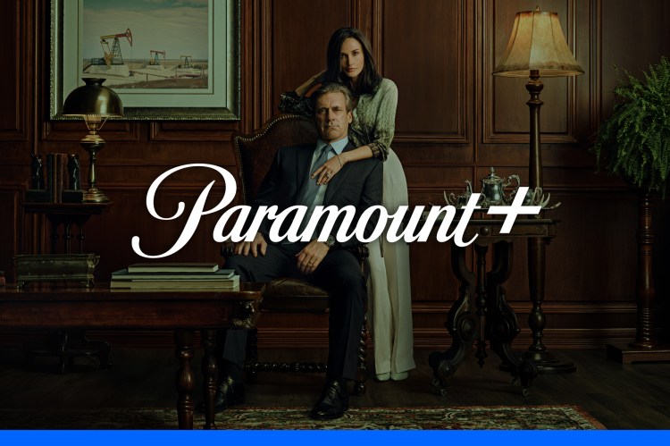 a man and woman sitting in front of a paramount logo