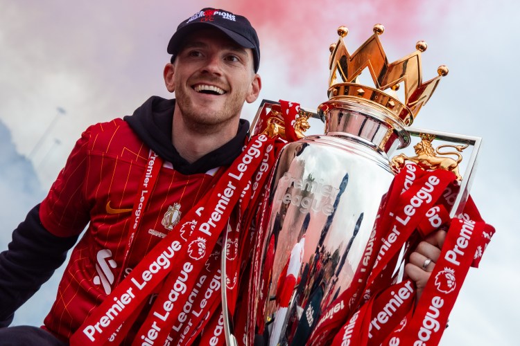 Andrew Robertson of Liverpool FC with the Premier League trophy and fans.