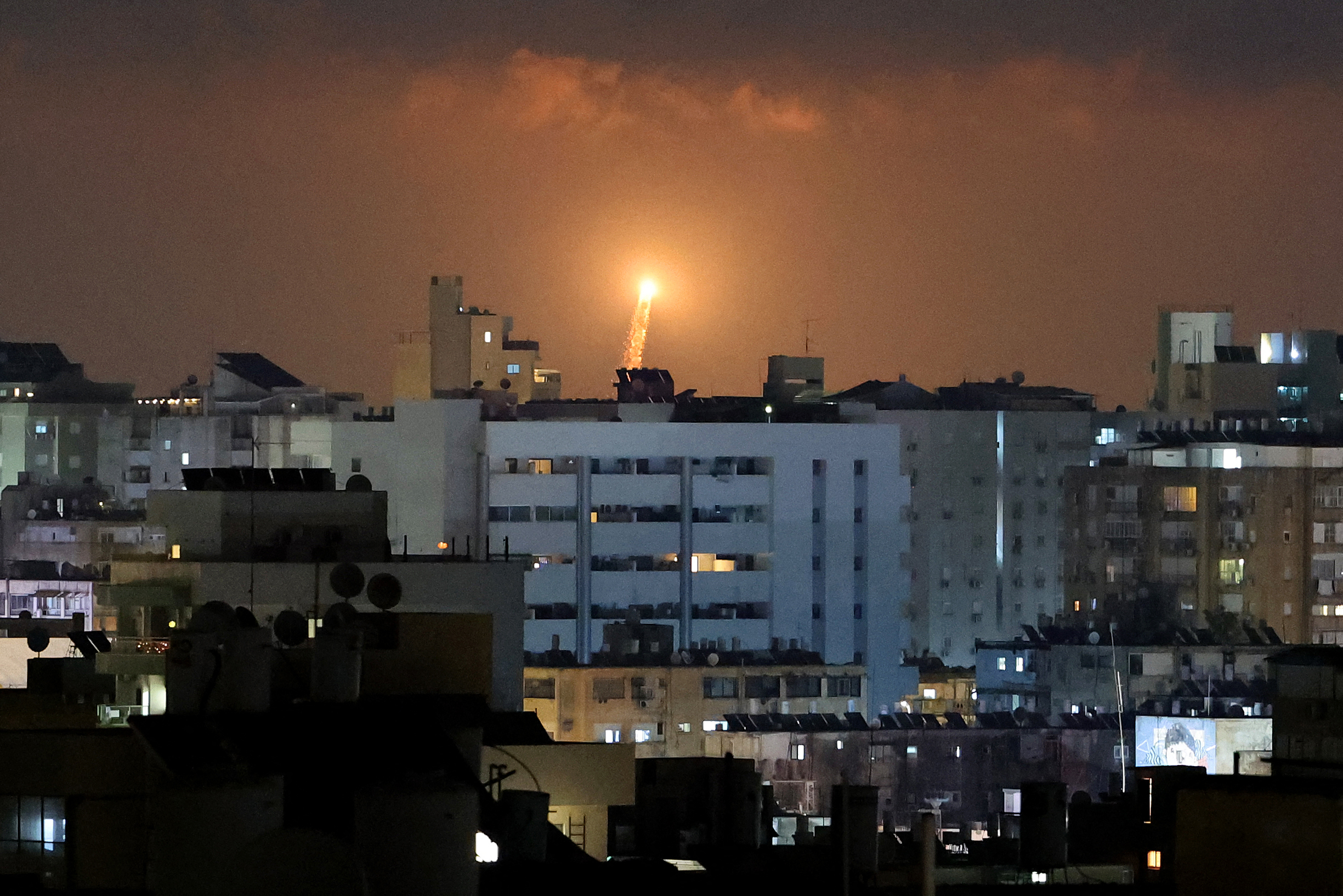 Rocket trails are seen above the Israeli coastal city of Netanya