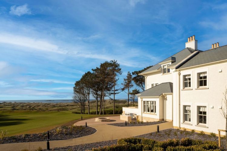 Dunluce Lodge overlooking a golf course and ocean.